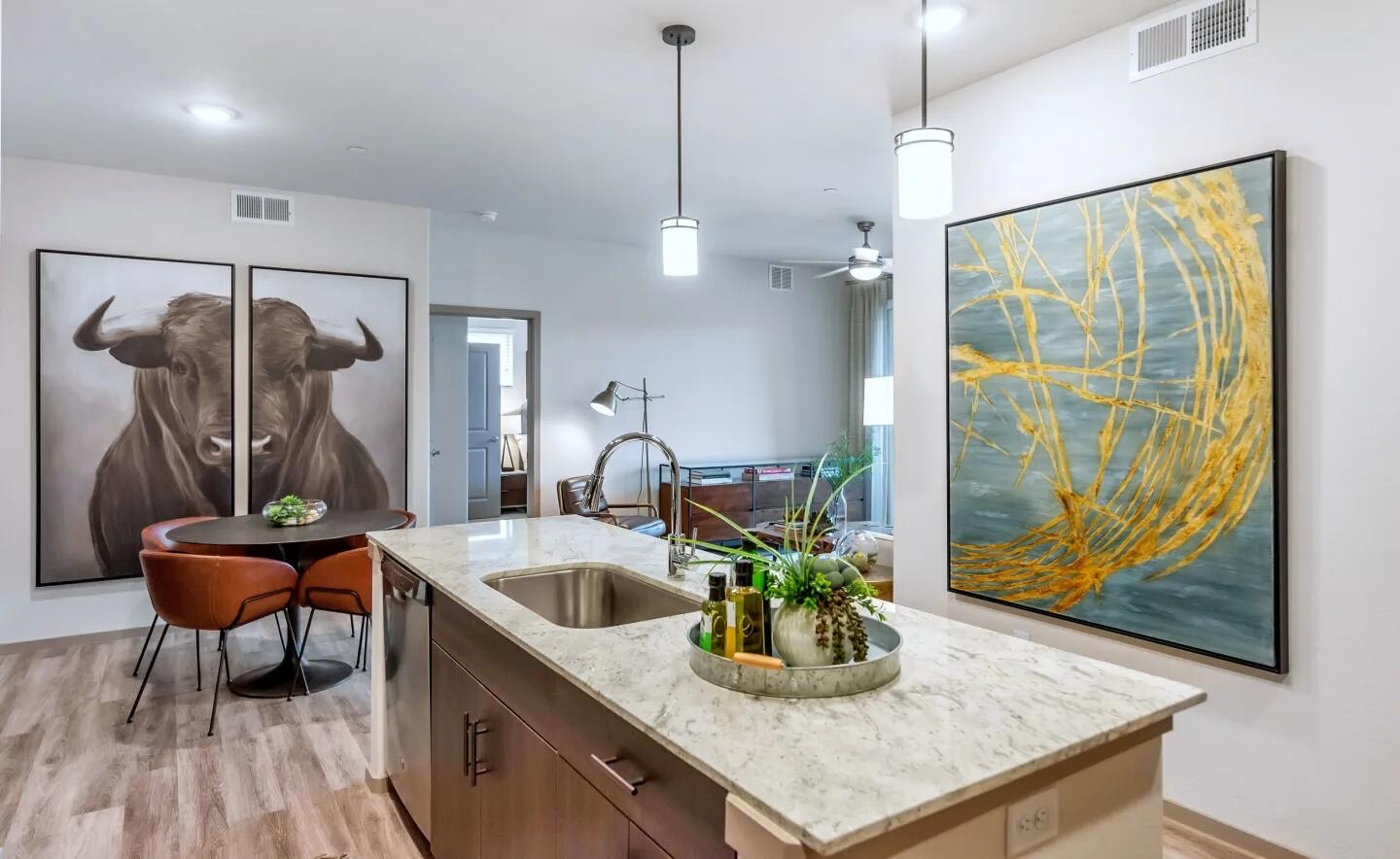 Open-plan kitchen with a granite island countertop and undermount sink