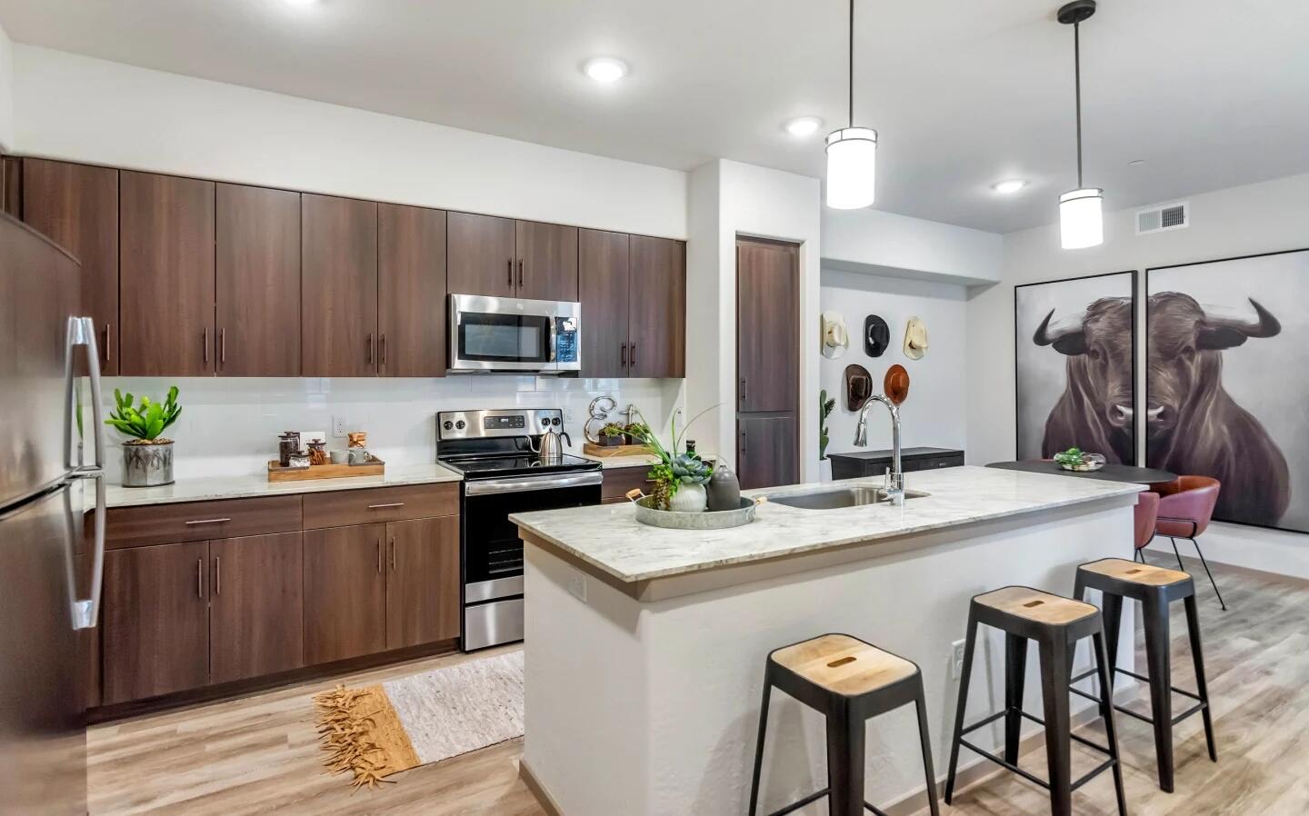 Kitchen island with a light granite countertop and undermount sink
