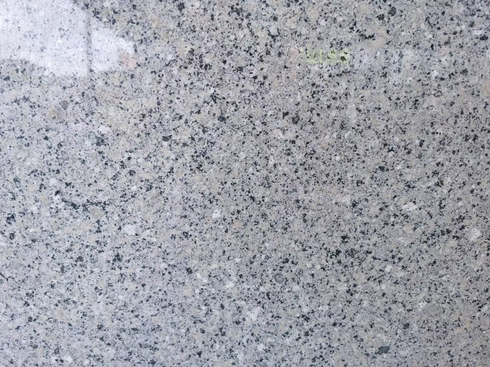 Pearl Blue granite slab, light grey with fine dark speckles