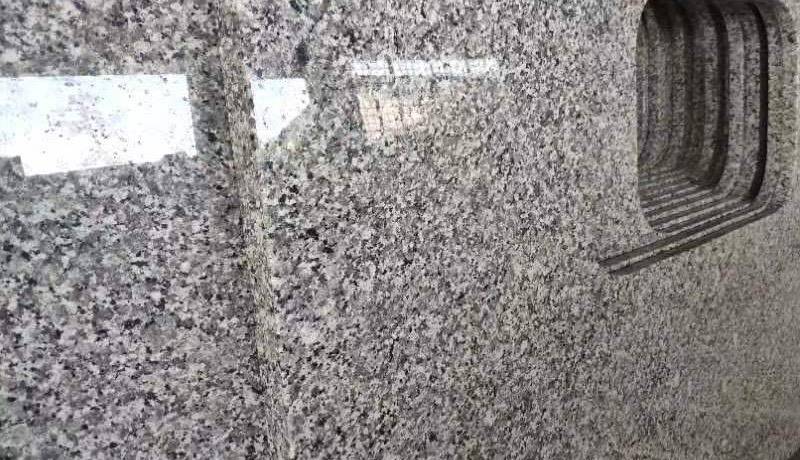 Swan Grey granite countertop with drainer grooves beside the sink cutout